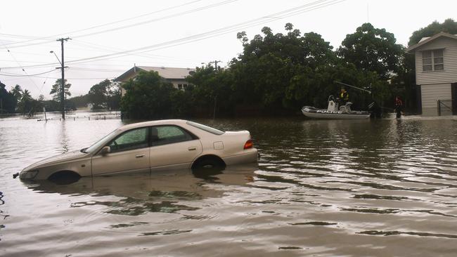 A Queensland Police Service rescue boat navigating floodwaters on the inundated intersection of Davidson and McIlwraith Street just off the Bruce Highway in Ingham. Picture: Cameron Bates