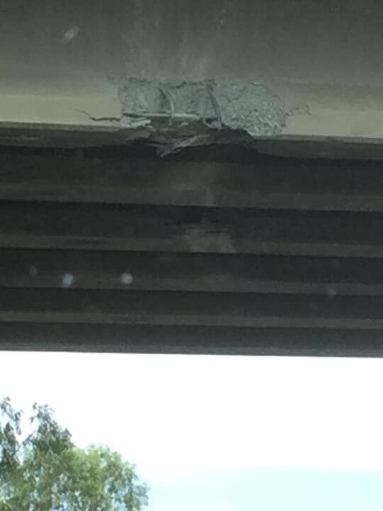 Damage to the Redbank Plains Road bridge after it was struck by a truck carrying an excavator.