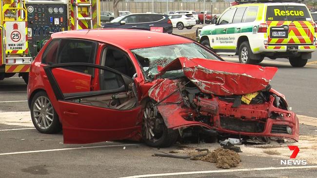 A driver was taken to hospital with serious injuries after his car slammed into a building at Adelaide Airport. Police were called to Comley St around 2pm after the Volkswagen hatchback left the road and crashed into a wall. Picture: 7NEWS