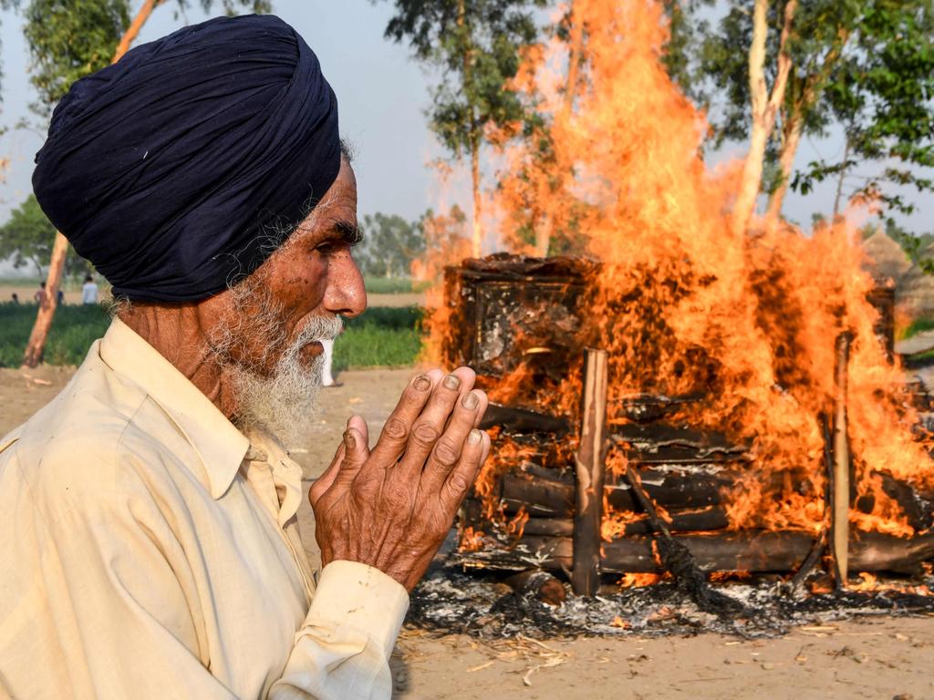 Jagir Singh stands next to the burning pyre of his son, soldier Satnam Singh who was killed in a recent clash with Chinese forces in the Galwan valley area. Picture: NARINDER NANU / AFP.