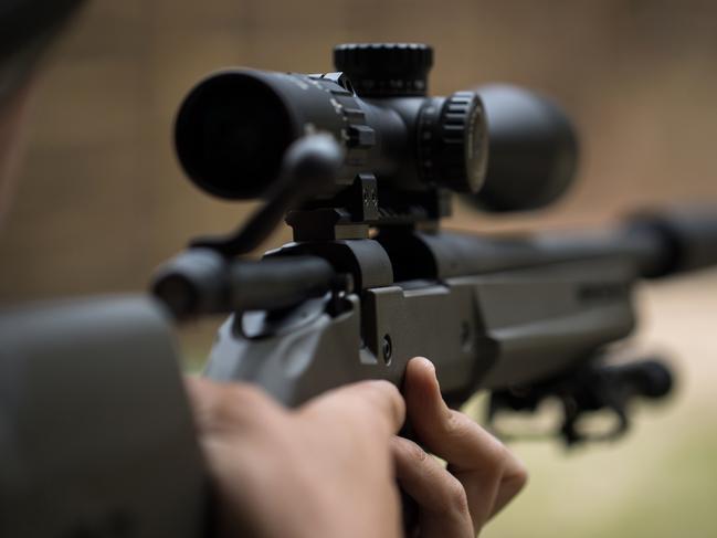 Sniper shooting rifle by looking through a scope. Picture: iStock/Artem Zakharov