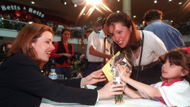 Teresa Saaib, 4, presents Tina Arena with a bunch of flowers as her mother Laura Saaib watches on. Her October 1995 visit was a year before the Aria singer released hits <i>Wasn’t it Good </i>and <i>Sorrento Moon</i>.