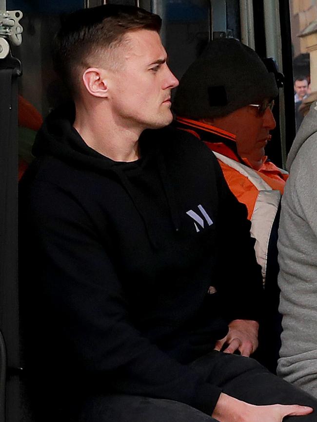 Brother Luke O’Shaughnessy waits in a police van to make a statement. Picture: Toby Zerna