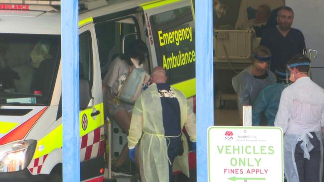 A University of NSW student who returned to Sydney from Wuhan last week arrives at Westmead Hospital after testing positive to coronavirus. Picture: TNV