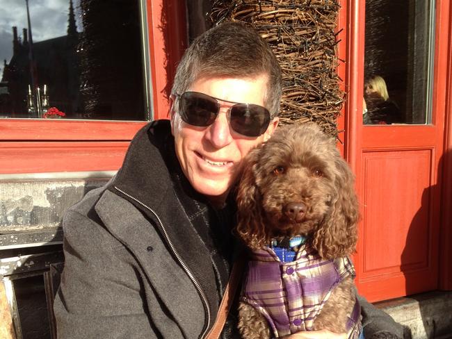 Wayne Smith with Charlie the miniature poodle who was banned from entering a lift under a bylaw. Picture: Supplied