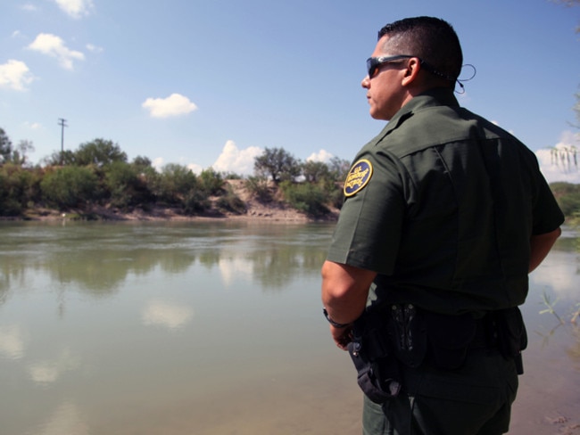 A real border patrol agent looks at Mexico across the Rio Grande in Texas.