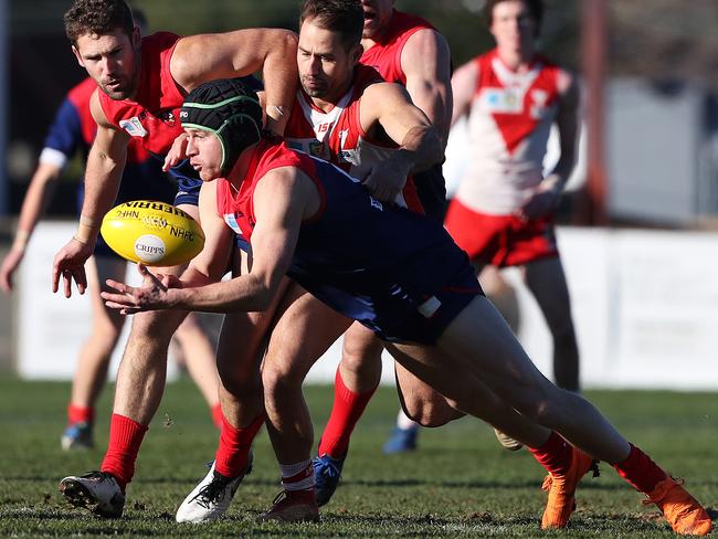 Football. Tasmanian State League. North Hobart V Clarence. Nathan McCulloch North Hobart handballs the ball away from Hugh NJ Williams North Hobart and Clint Riley Clarence. Picture: NIKKI DAVIS-JONES