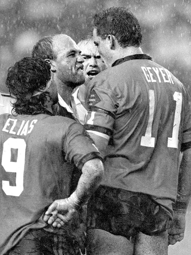 This iconic Origin picture captures Wally Lewis and Mark Geyer fronting up to each other in 1991 as Benny Elias and the referee look on. Picture: Geoff McLachlan