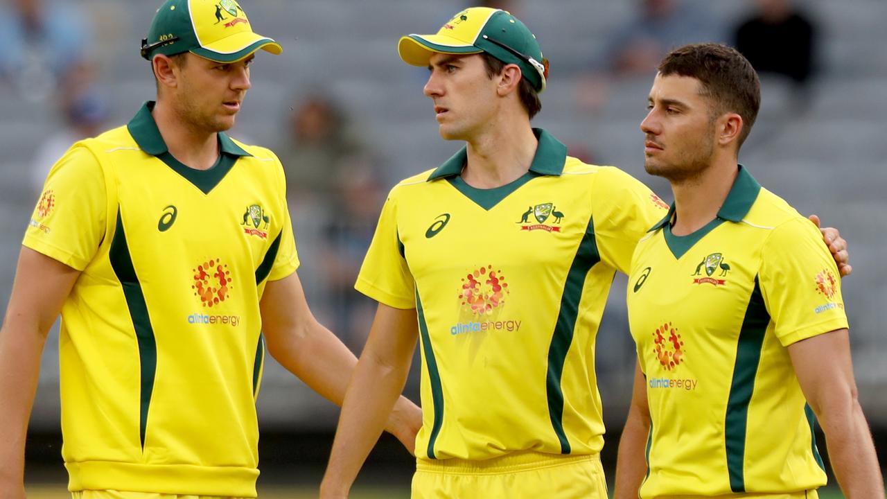 Josh Hazlewood, Pat Cummins and Marcus Stoinis of Australia react to the loss to South Africa in Perth.