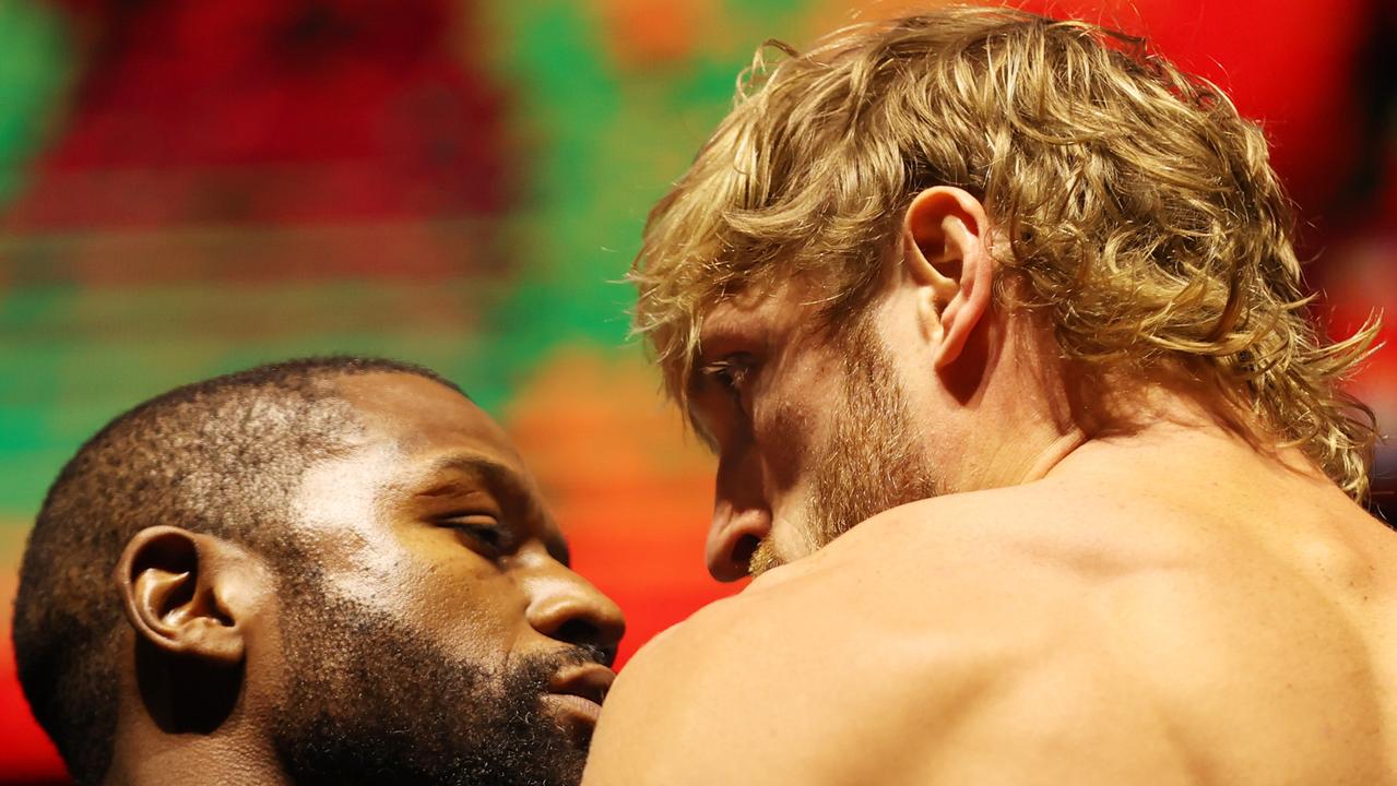 MIAMI GARDENS, FLORIDA - JUNE 05: Floyd Mayweather and Logan Paul face off during their weigh-in ahead of their June 6 exhibition boxing match on June 5, 2021 at Hard Rock Live at Seminole Hard Rock Casino in Miami Gardens, Florida. (Photo by Cliff Hawkins/Getty Images)