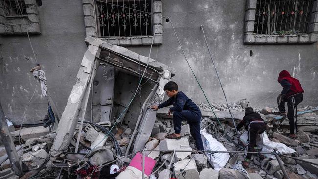 Children inspect the damage following Israeli bombardment in Rafah. Picture: AFP