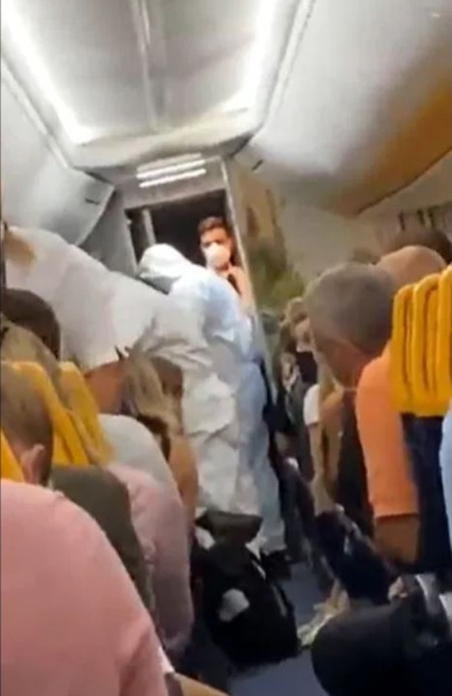 Workers in full hazmat suits escorted the passenger off the plane. Picture: Twitter/@fionnmurphy10
