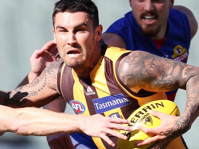 AFL - Sunday, 13th September, 2020 - Hawthorn v Western Bulldogs at the Adelaide Oval. Hawthorn's Chad Wingard tries to break the tackle of Western Bulldogs Lachie Hunter Picture: Sarah Reed