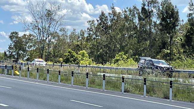 Police officers on the side of the Pacific Highway north of Taree near the Ghinni Ghinni Bridge on Wednesday afternoon, February 14.