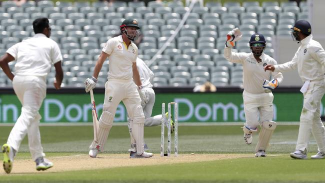 Indian players celebrate after Australia's Shaun Marsh is dismissed during the first Test between Australia and India in Adelaide.