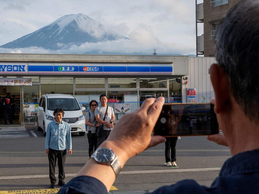 Fujikawaguchiko mounted a large barrier at a popular viewing spot of Mount Fuji. Picture: AFP