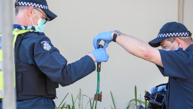 Police hold an axe. Picture: Jay Town