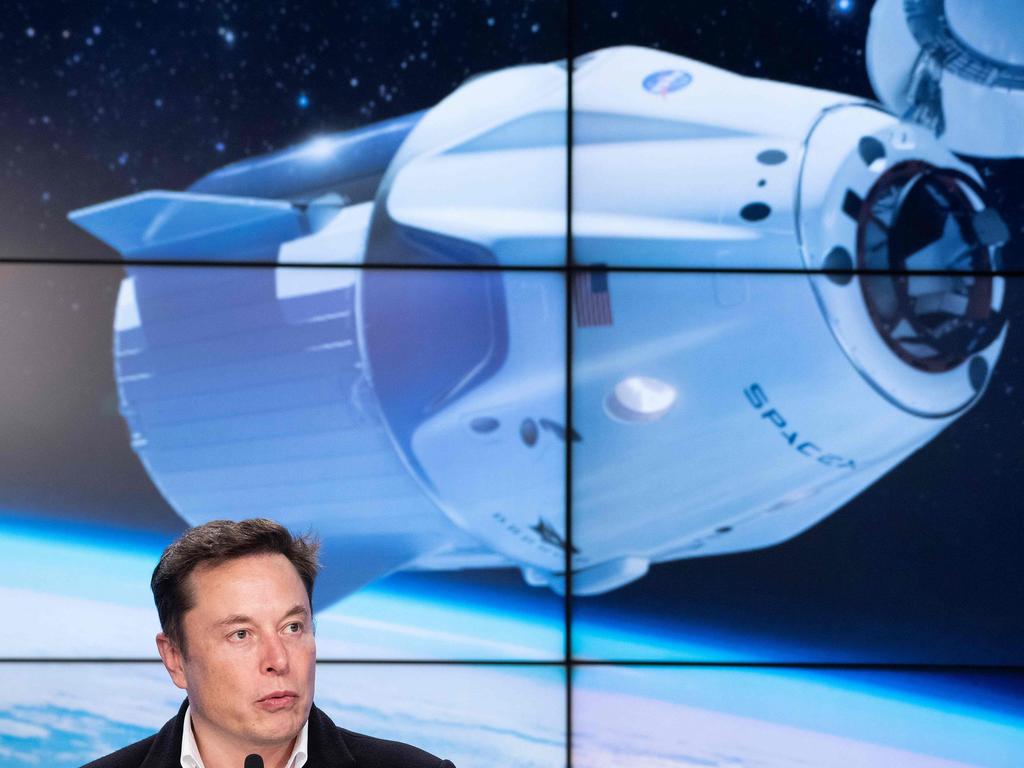 (FILES) In this file photo taken on March 2, 2019 SpaceX chief Elon Musk speaks during a press conference after the launch of SpaceX Crew Dragon Demo mission at the Kennedy Space Center in Florida. - SpaceX announced a new partnership February 18, 2020, to send four tourists deeper into orbit than any private citizen before them, in a mission that could take place by 2022 and easily cost more than $100 million. The company signed the deal with Space Adventures, which is based in Washington and served as an intermediary to send eight space tourists to the International Space Station (ISS) via Russian Soyuz rockets. (Photo by Jim WATSON / AFP)