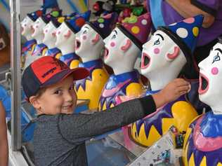 CLOWNS: Ayden Henry playing with the clown heads at the 147th Dalby Show. Picture: Mick Doyle