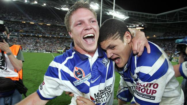 Willie Mason and Corey Hughes celebrate after the GF triumph over the Roosters.