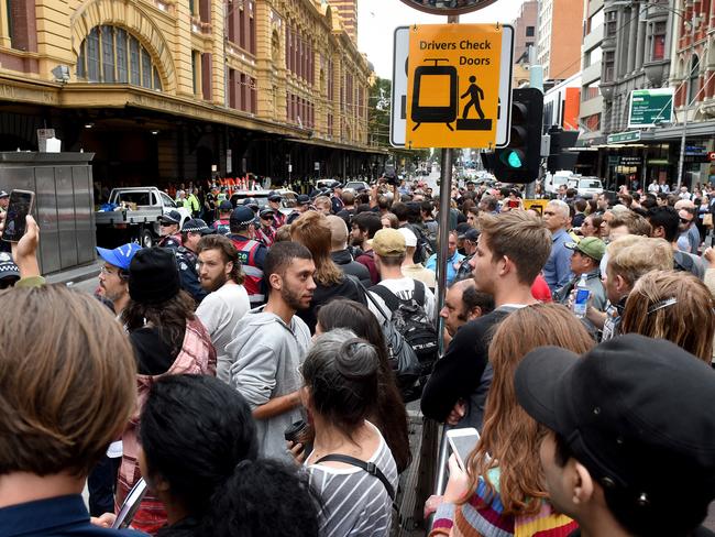 Crowds of people look on as police move in to move rough sleepers. Picture: Kylie Else