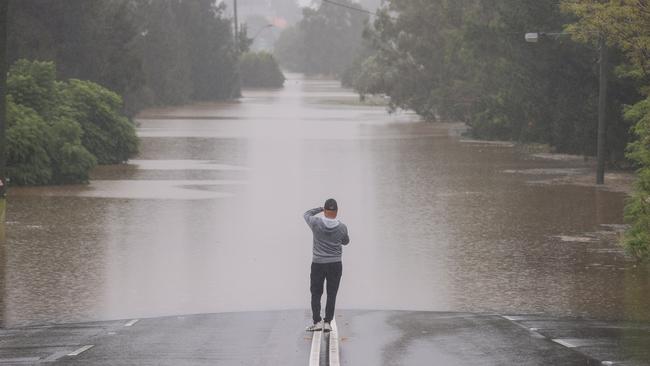 A man stands on Windsor Road in McGraths Hill, Sydney. Picture: Getty Images