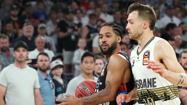 Melo Trimble puts some body on Brisbane’s Nathan Sobey. Picture: Michael Klein