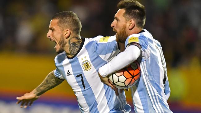 Argentina's Lionel Messi (R) celebrates with teammate Dario Benedetto.
