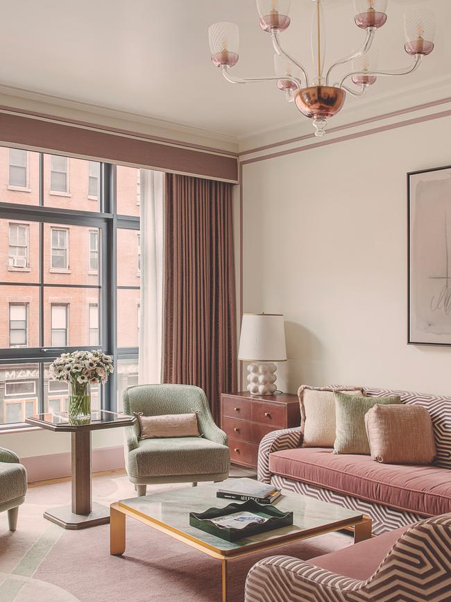 A corner suite at the Hotel Barrière Fouquet’s New York with Hudson River views features a generous living room, playful lighting and a palette of dusty pink and pale green.