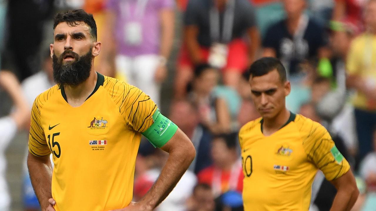 Australia's Mile Jedinak and Trent Sainsbury react after Peru score their 2nd goal