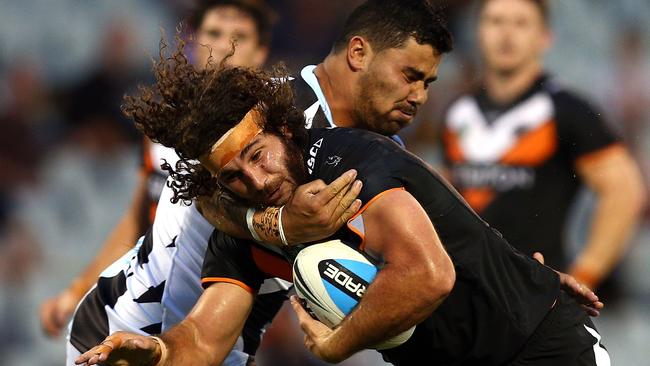 Brenden Santi of the Tigers is tackled by David Fifita of the Sharks during the NRL Trial Match between the Wests Tigers and the Cronulla Sharks at Campbelltown Sports Stadium on February 21. Photo: Renee McKay/Getty Images