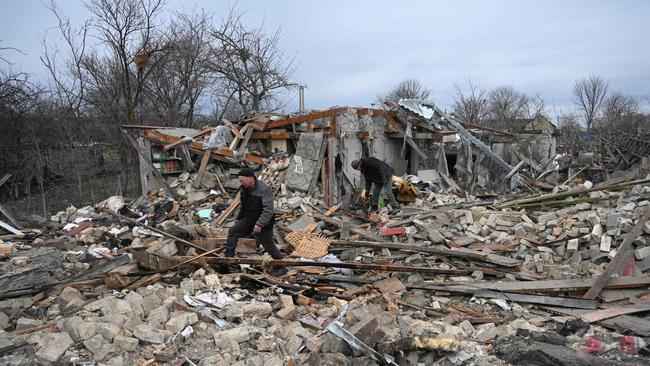 People search the rubble of a house following a Russian strike in the village of Velyka Vilshanytsia, some 50km from Lviv (Photo by YURIY DYACHYSHYN / AFP)