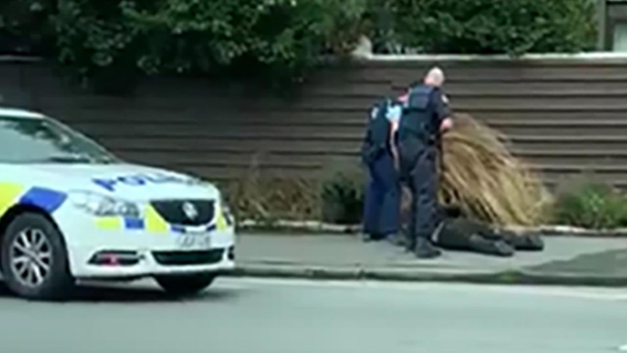 Police hold a suspect to the ground following the mass shooting. Picture: Mary Outram 