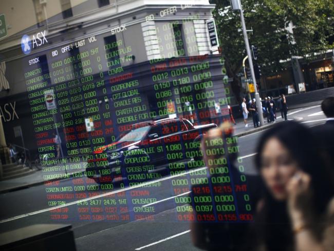 Pedestrians are reflected in a window as they walk  past an electronic stock board at the ASX Ltd. exchange centre in Sydney, Australia, on Thursday, Feb. 14, 2019. âWe made good progress on our core initiatives across the period, including the program to replace CHESS with distributed ledger technology; upgrade of our secondary data centre to strengthen market resilience; and restructure of our Listings Compliance team to enhance the quality of market oversight,â ASX Chief Executive Officer Dominic Stevens said. Photographer: David Moir/Bloombergrket resilience; and restructure of our Listings Compliance team to enhance the quality of market oversight,â ASX Chief Executive Officer Dominic Stevens said. Photographer: David Moir/Bloomberg