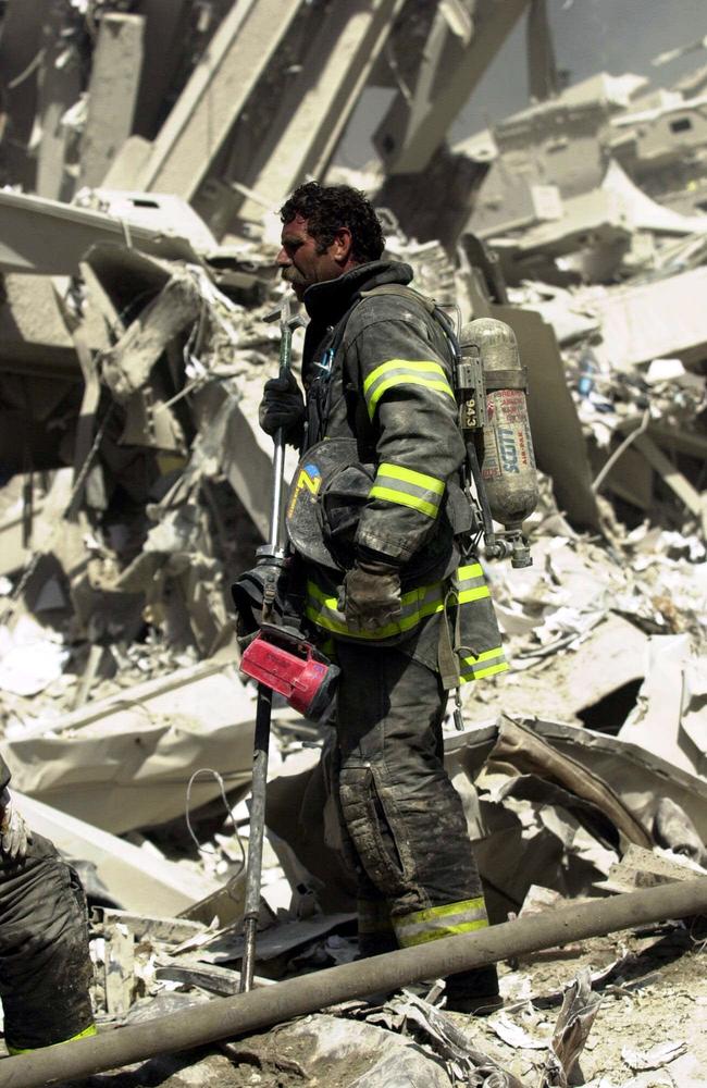 A firefighter stands among rubble of New York's World Trade Centre. Picture: Nathan Edwards