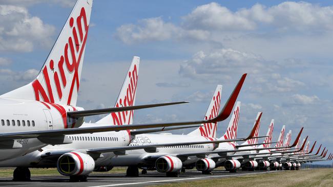Grounded Virgin Australia aircraft are seen parked at Brisbane Airport in April. Picture: AAP
