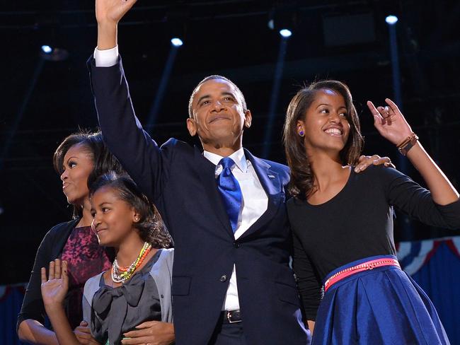 US President Barack Obama, First Lady Michelle and daughters Sasha and Malia wave to supporters on election night November 6, 2012. Picture: Jewel Samad/AFP Photo