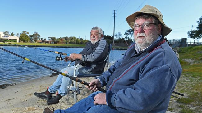 Mike Nicholls (background) and Sandy Blythman fishing at West Lakes in August. Picture: Tom Huntley