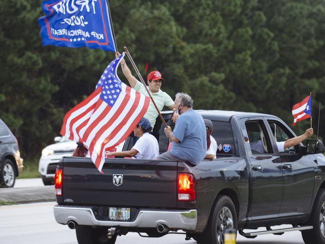 Trump supporters ride in the back of a ute in Florida. Picture: Angus Mordant for NewsCorp Australia