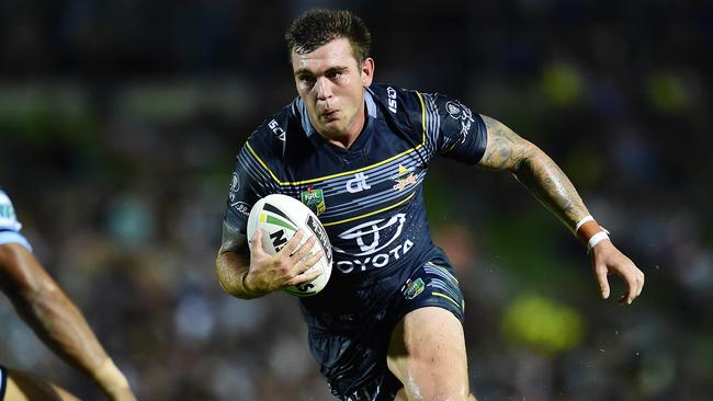 NRL Round 1 match between the NQ Cowboys and the Sharks in Townsville, QLD, at 1300 SMILES Stadium. Cowboy's Kyle Feldt and Shark's Ricky Leutele. Picture: Wesley Monts