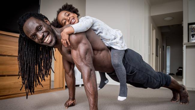 Personal trainer Paapa Kweku Aboagye, with daughter Azariyah, 3, practices strong positive reinforcement by tapping into his children's strengths. Picture: Jake Nowakowski