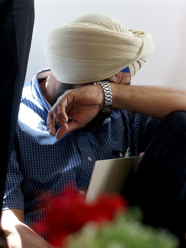 A man is overcome by grief at the temple.