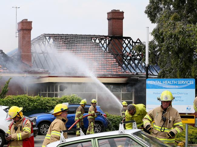 Firefighters pump water into the smouldering Peacock Centre in North Hobart. Picture: SAM ROSEWARNE