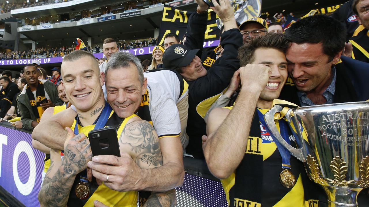 Dustin Martin and Rance celebrate with fans after winning the 2017 Grand Final.