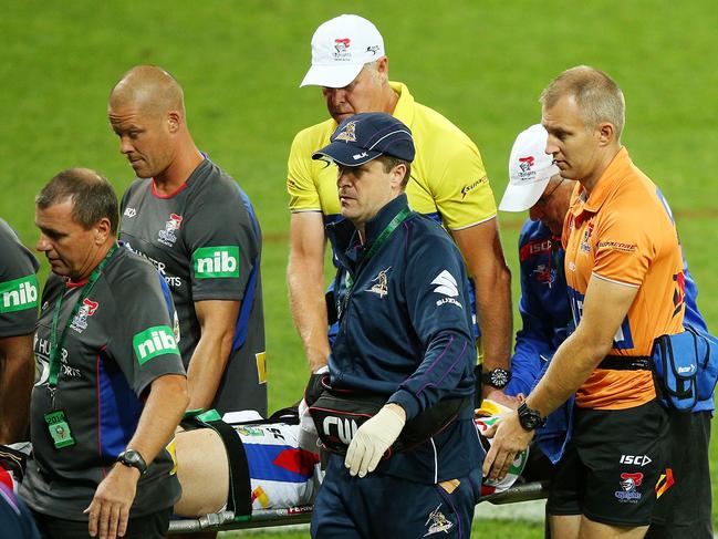 Alex McKinnon of the Knights is carried off an a stretcher after the tackle which changed his life. Picture: Getty Images