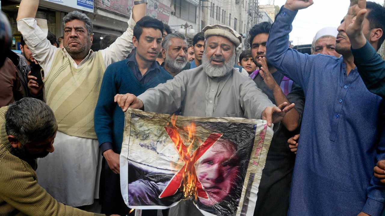 Pakistan traders burn a poster with the image of Brenton Tarrant, the man charged in relation against the March 15 attack on two mosques in Christchurch, during a protest in Peshawar on March 16, 2019. - A right-wing extremist armed with semi-automatic weapons rampaged through two mosques in the quiet New Zealand city of Christchurch during afternoon prayers on March 15, killing 49 worshippers and wounding dozens more. (Photo by ABDUL MAJEED / AFP). Picture: ABDUL MAJEED