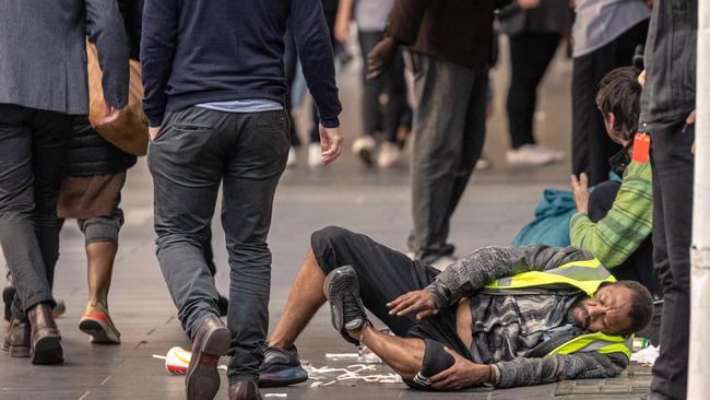 A man at the corner of Elizabeth and Flinders streets in Melbourne’s CBD.