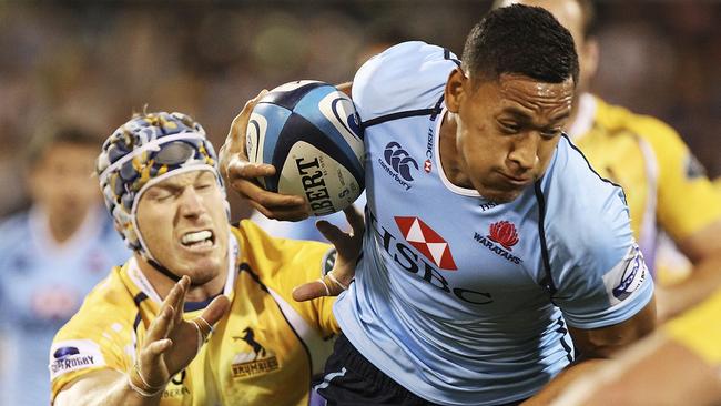 Israel Folau of the Waratahs is tackled by David Pocock of the Brumbies.