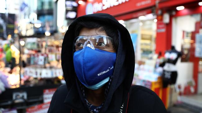 A man wears a mask in the Myungdong shopping district in Seoul, South Korea. Picture: Getty Images