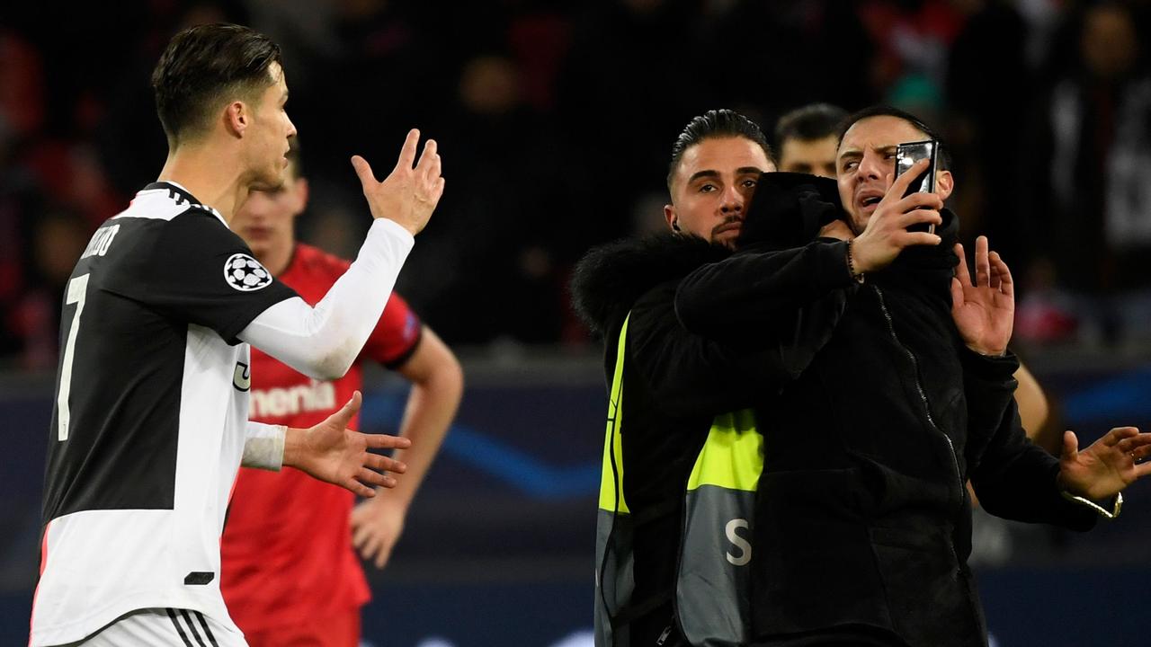 Ronaldo was enraged at a reckless pitch invader (R) after Juventus claimed a Champions League win.